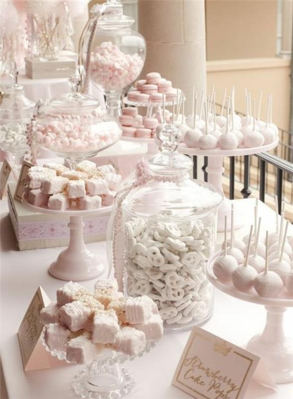 elegantna poročna sladkarija v roza in beli barvi, majhne torte, lizike za torte, makroni in sladkorni mandlji, okrasne škatle, izložba torte, zlata črka