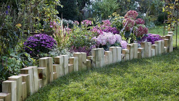 leseni bloki, posajeni v zemljo na različnih višinah, da naredijo rustikalno leseno vrtno obrobo