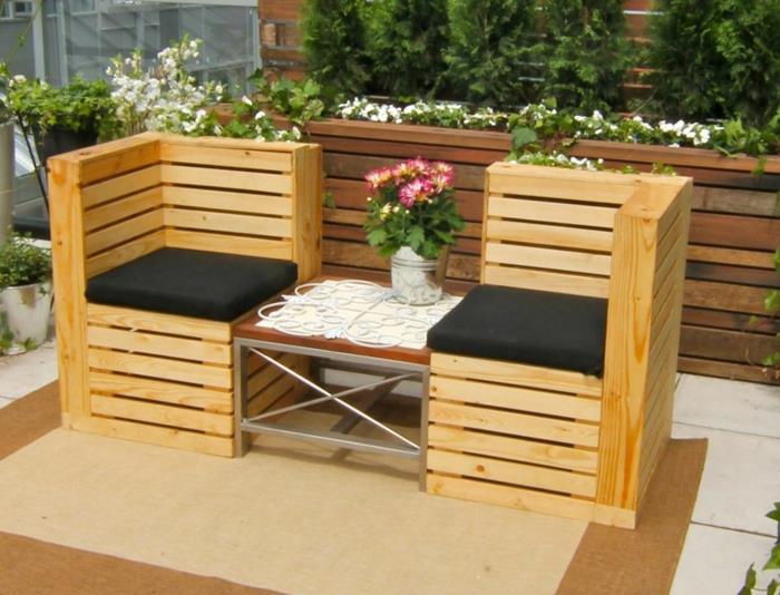 suoliukas padėkle, sodo stalas padėkle, dvi juodos kvadratinės pagalvėlės, kvadratinis stalas, padengtas maža balta nėrinių staltiese