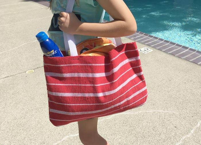 Kırmızı ve bej çizgili plaj çantası, havuzda kadın, çanta anlatımı, kumaş çanta modeli, bez çanta anlatımı