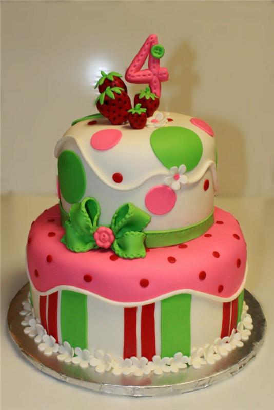 rožinės, baltos ir žalios spalvos gimtadienio pyragas, ant viršaus raudonos braškės, raudonų taškelių apdaila
