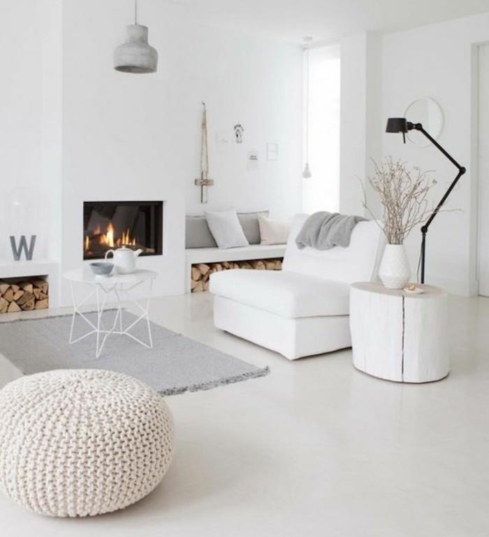 pilkos svetainės bangos, baltas fotelis ir pufas, pilkas kilimas, mažas baltas metalas, kavos staliukas, medinis šoninis stalas