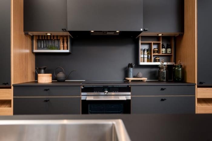 aukštos ir žemos matinės juodos spalvos virtuvės komplektai su šviesia medžio apdaila ir LED apšvietimu, įrengta virtuvė