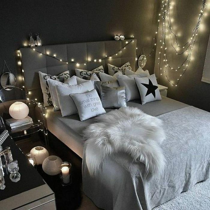 sukurkite savo šiuolaikišką miegamojo dekorą, šviesią girliandą, baltą kailį, baltas pagalvėles, pilkus dažus