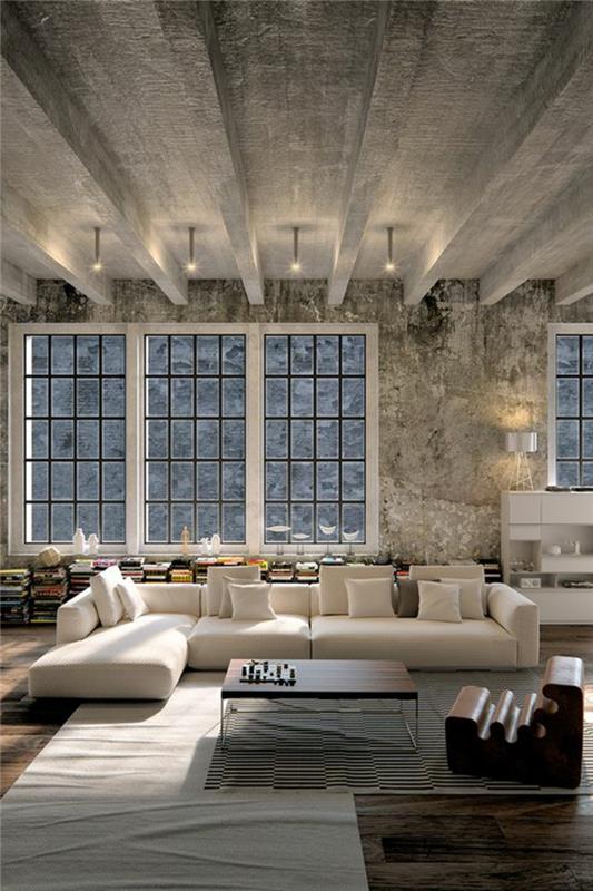 svetainės dekoro idėja, pramoninio stiliaus betoninės lubos, šviesios spalvos sofa, knygos ant grindų