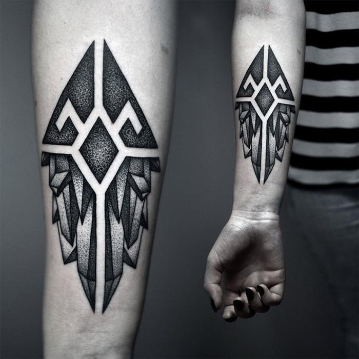 Tatuiruočių maschile sul braccio con il disegno di teta forme geometriche
