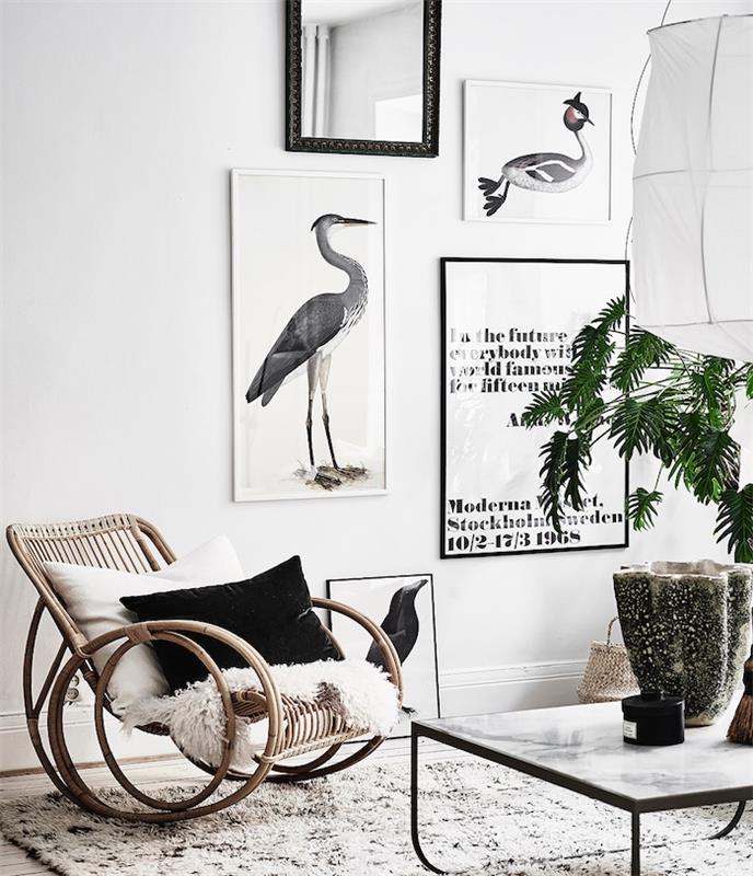 črno -beli model preproge za čahure, leseni stol za zibanje, mehko krzno, črno -bela okrasna blazina, okrasne slike, zelena rastlina
