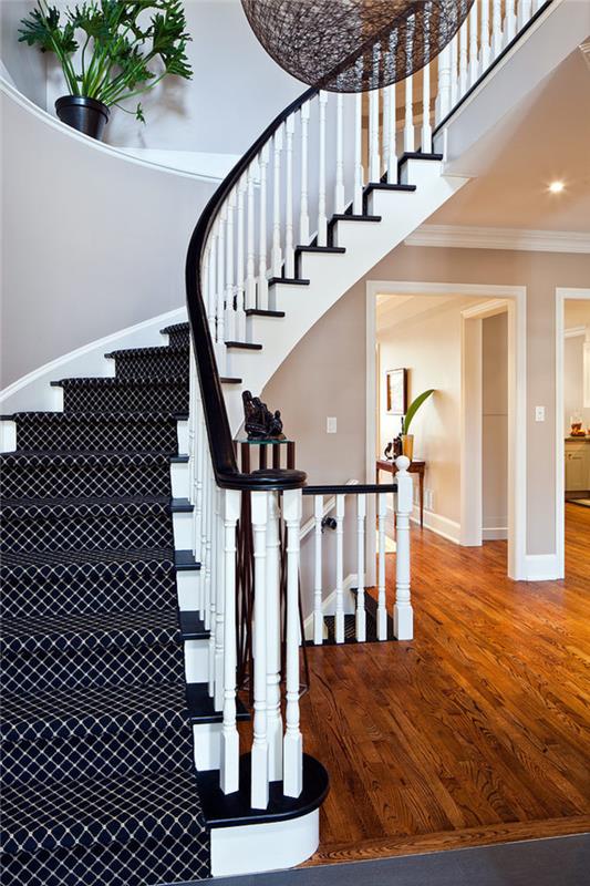 laiptai perdažyti balta ir juoda su kontrastingais laipteliais ir pakilimais, padengti kilimu su grafiniu raštu