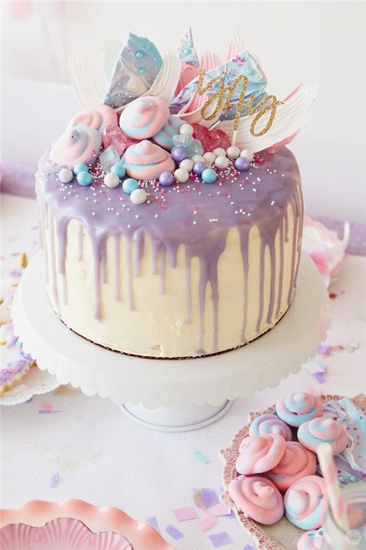 lepa samorogova torta s sivkasto rožnato tekočo glazuro z okrasom iz enorogovih meringue in barvnimi sladkornimi biseri