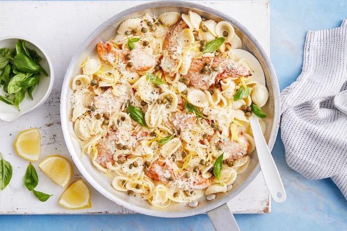 Orecchiette al sugo di formaggi, fette di limone, foglie di basilico, padella con testenine, cena sfiziosa