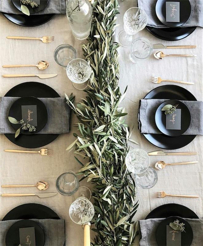 dökmeyen bir masa koşucu altın çatal bıçak takımı ve gri peçeteli siyah tabaklar ile yeni yıl temalı fikir