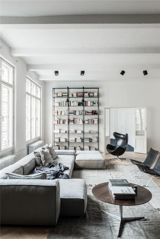 svetainės dekoro idėjos, patogi sofa, apvalus stalas, juoda kiaušinių kėdė, minimalistinė lentyna