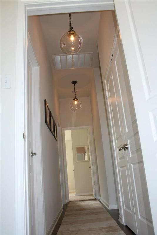 illuminazione-corridoio-stretch-lungo-pavimento-parquet-tappeto-lampade-soffitto-decorazione-pareti-quadri