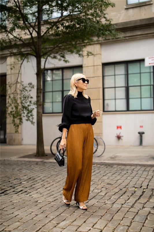 Navdihujoča fotografija obleke za ženski dan jeseni, ideja za razgrnjene hlače in črno majico z dolgimi rokavi, sodobna sončna očala