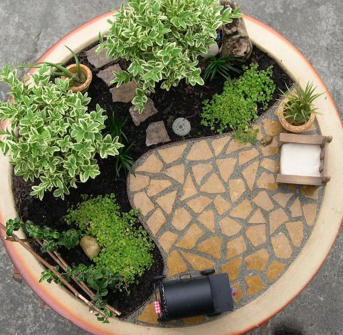 majhen miniaturni japonski vrt v lončku z mini rastlinami in modeli