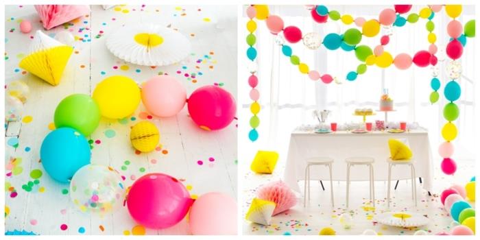 baltas kambarys su ryškių spalvų plaukiojančių balionų girliandomis, blizgučiais, baltu stalu ir taburetėmis
