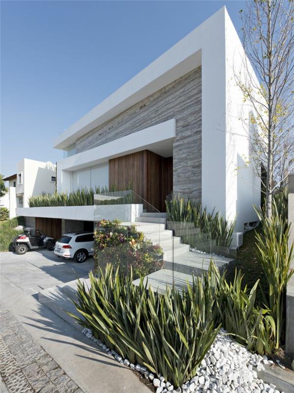 gražūs namai-su-minimalistiniu-išoriniu-dekoratyviniu-akmenukais-baltais ir žaliais augalais