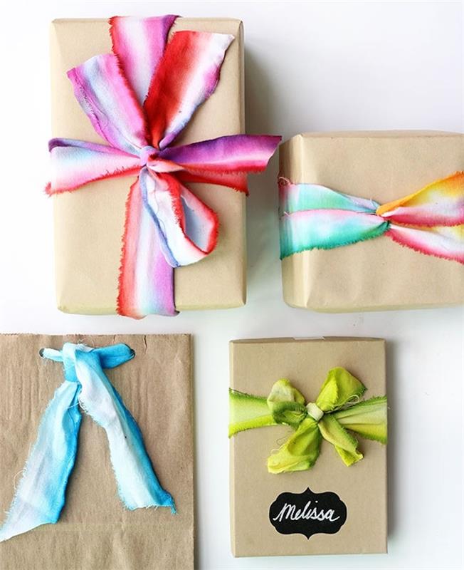 amatų maišelis ir kartoninė dovanų dėžutė, įvyniota į kraftpopierių, spalvinga akvarelės efekto kaklaraištis ir dažų juostelė
