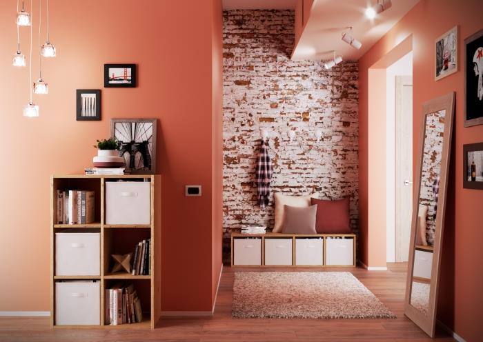 kırmızı ve beyaz tuğla bölümlü turuncu duvarlı deco salon girişi, ipli ve cam ampullü hafif süspansiyon modeli