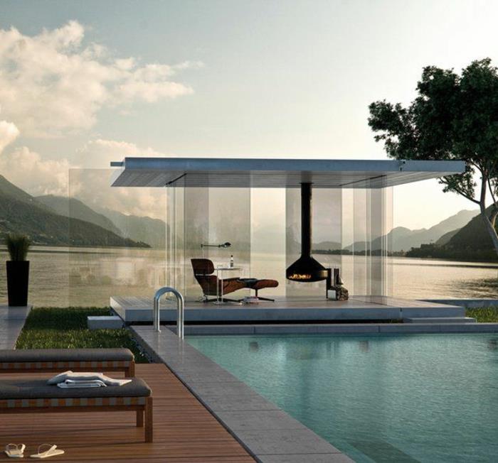 minimalizmas architektūroje su moderniu baseino stiklo sienomis ir vidaus židiniu