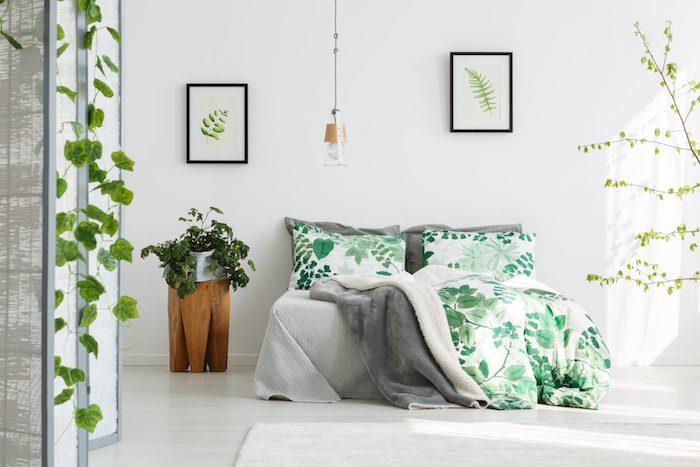 Beyaz duvarlar ve yeşil vurgularla sade bir şekilde dekore edilmiş güzel yatak odası, duvara düşen yeşil sarmaşık bitkisi, bohem şık yatak odası, yeşil houseplant egzotik dekor
