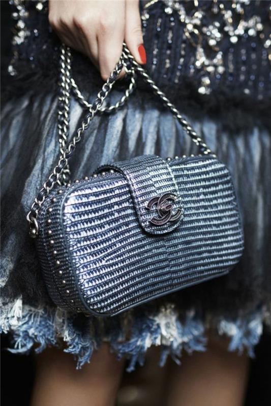mini Chanel torba z mavričnimi odtenki, z logotipom črne kovine, kovinsko verižico v srebrni barvi, krilom z belimi in sivimi robovi perja, eleganten večer in šok, kako se obleči
