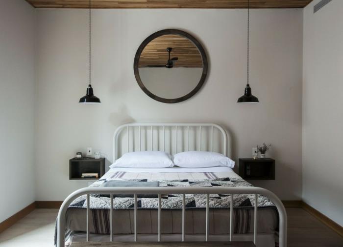 İskandinav tarzı bir yatak odası, yüzer komodin ve endüstriyel aydınlatma