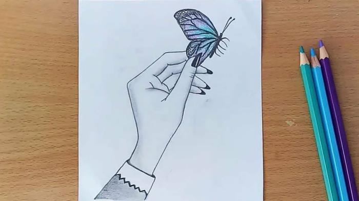 Mėlynas drugelis ant drugelio dažantis rankų piešinį, gražios spalvos drugelio pelėdos piešinys