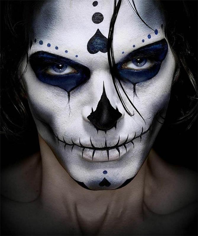 skeleto veidas susiuvamomis lūpomis, įdomios figūros ant kaktos ir smakro