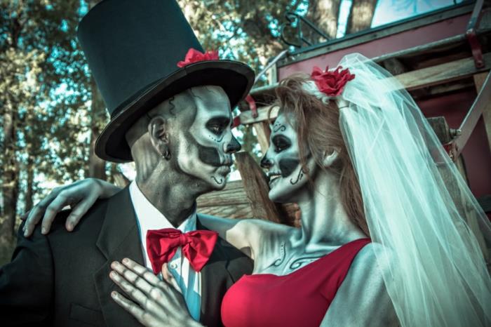 skeleto vestuvės, baisus makiažas, balta šydas, cilindrinė skrybėlė, raudona suknelė, raudonas drugelis