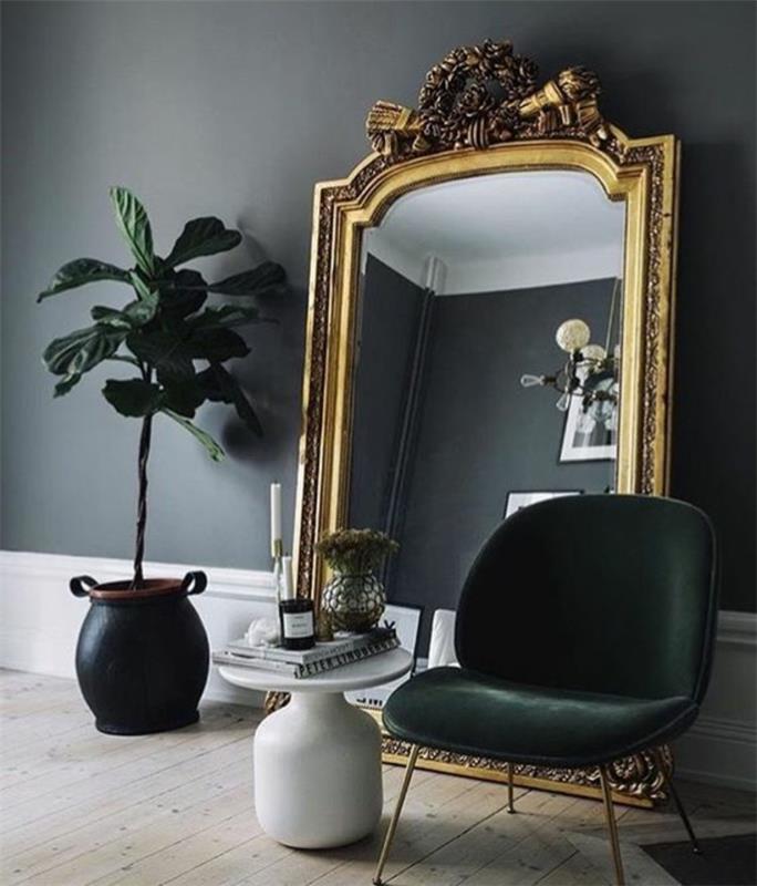 baroko baldai didžiulis veidrodis, kad pamatytumėte visą kambarį su juodu foteliu be porankių ir augalų puodą juodai