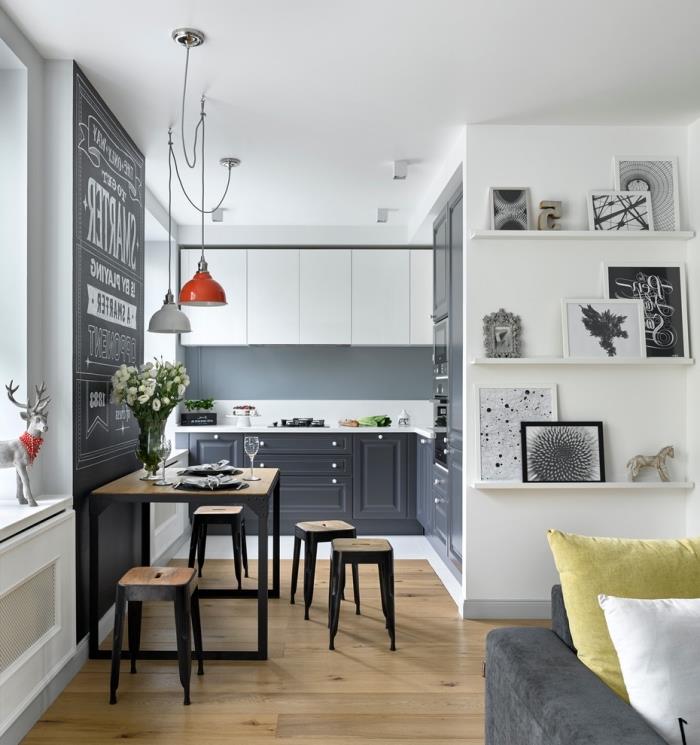 Skandinavski dizajn, kuhinjska postavitev odprta za dnevno sobo, kuhinjsko pohištvo v beli in črni barvi