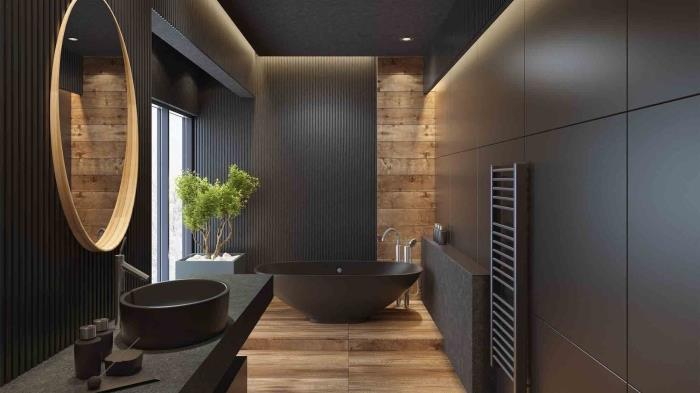 juoda vonios kambario apdaila su juodomis sienomis su medžio imitacijos lentų grindimis, laisvai stovintis vonios matinės juodos spalvos modelis