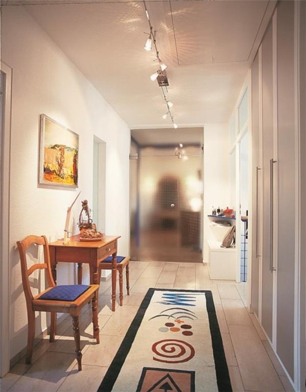 mobili-per-corridoio-tavolino-legno-sedie-tappeto-colorato-illuminazione-moderna-soffitto