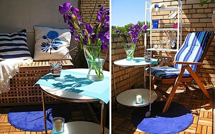 Ozka postavitev balkona z opečnimi stenami, lesena talna obloga, okrasne blazine v beli in modri barvi, klubska mizica s kolesi, vaza s cvetjem