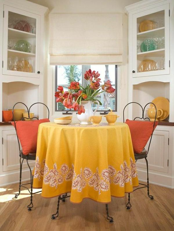 geltonos spalvos staltiesė-kaltinė-staliukas-kėdės-langai-stalo-gėlės