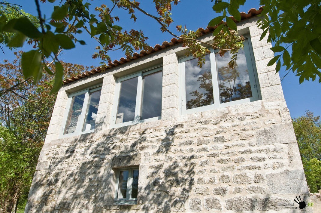 Finestre moderne con doppi vetri sulla facciata di una vecchia casa