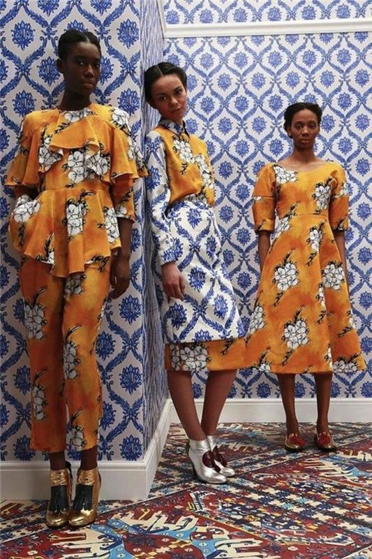 trije videzi, dve afriški obleki in en videz v hlačah, afriški vzorec, belo cvetje na oranžni podlagi, obleka s sežganim krilom in ravna obleka