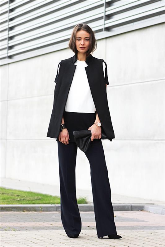 elegantna silhueta s čistimi linijami z ženskim smokingom v črnem jopiču brez rokavov in tekočimi hlačami