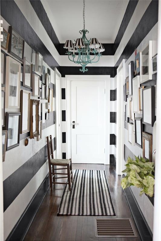 pareti-decoration-contrasto-bianco-nero-lampadario-sospensione-quadri-tappeto-sedia-legno