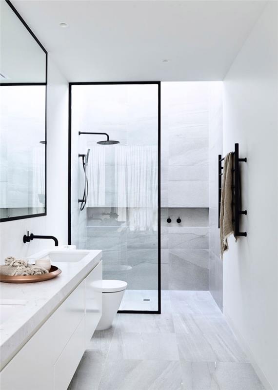 bela kopalnica s ploščicami iz belega marmorja in tuš kabino iz stekla in mat črne barve