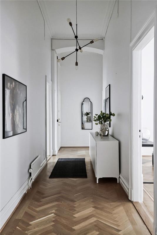 beli hodnik v skandinavskem slogu s črnimi poudarki, uvedenimi z majhnimi dotiki, beli skandinavski dekor hodnika