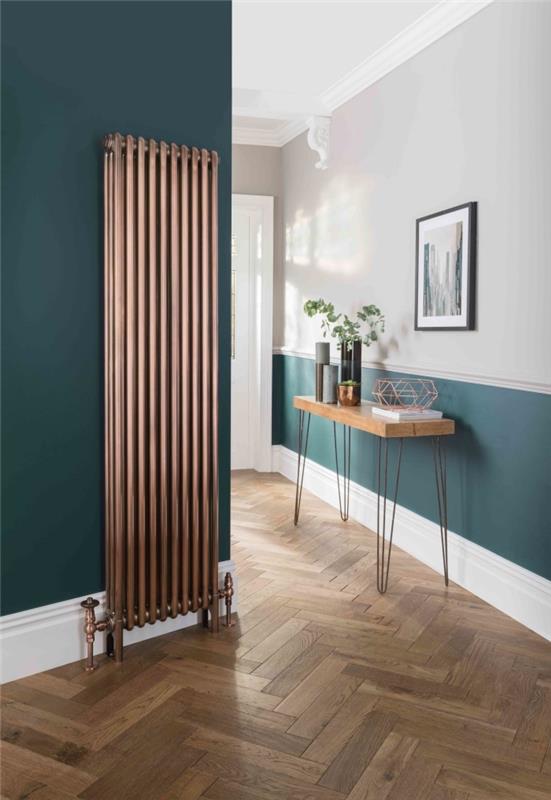 račja modra barva na dnu stene in sosednji steni se kombinira z lesom in radiatorjem v bakreni izvedbi, da vnese hodnik elegance v hodnik