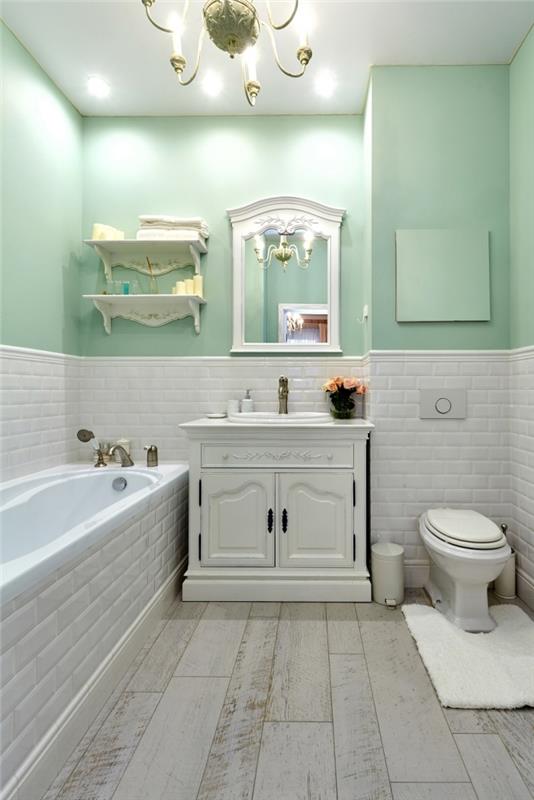 pastelinės žalios spalvos sienų dažai šalies prašmatnus dekoras su baltų plytų plytelėmis išklota vonia