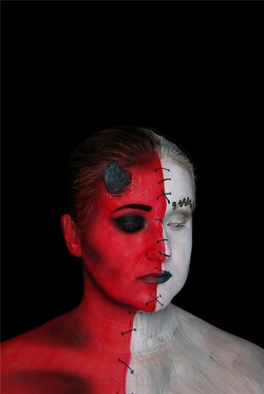 sanatsal iblis makyajı yarı melek yarı şeytan kırmızı ve beyaz su bazlı göz farı ile yapılmış, dikili yüz efekti