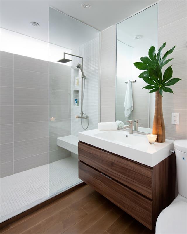 Majhna postavitev prostora, leseno pohištvo in ploščice, dekorativna ideja, bela črno -lesena postavitev kopalnice, vaza z zelenjem