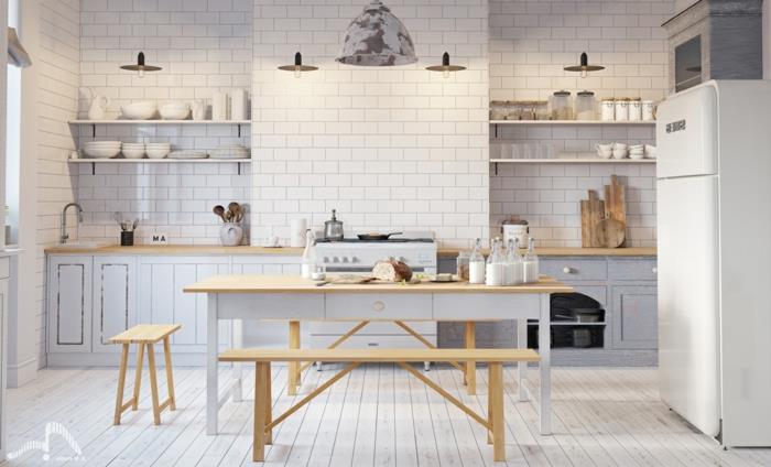 Skandinaviška virtuvė iš medžio ir baltos spalvos, keturi pakabinami šviestuvai, valgomojo stalas ir suolai, šviesios spalvos spintelės