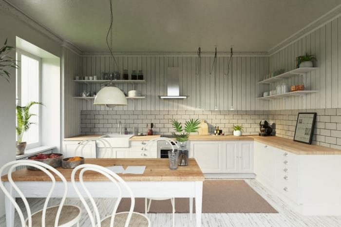 Skandinaviško dizaino virtuvė, apvalios kėdės, stačiakampis stalas, balintos parketo grindys, nedidelė l formos virtuvė