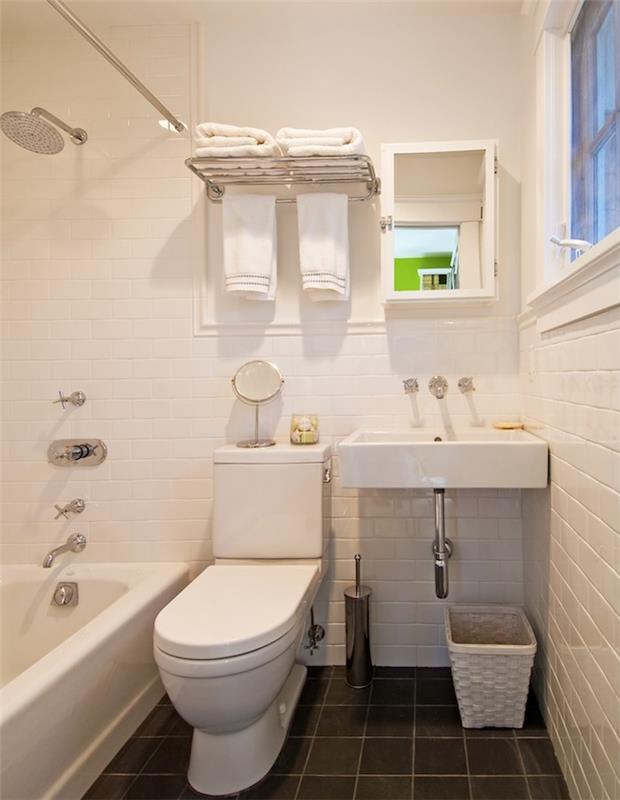 antrasit gri karo zemin, beyaz karo duvar, beyaz tezgah banyo, wc ve beyaz lavabo ile boyda küçük banyo