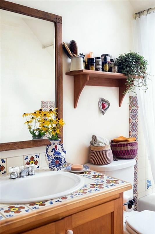 labai mažas vonios kambarys su gėlių plytelėmis ant senovinio stiliaus spintelės